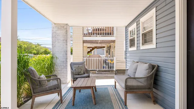 a balcony with furniture and a potted plant