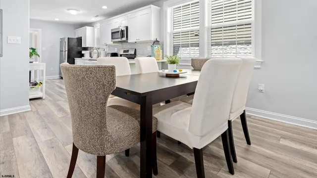 a dining room with furniture and window