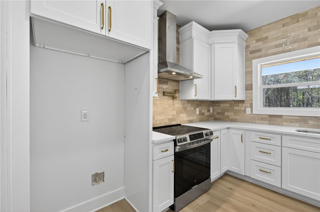 88 Carolyn Path Rockmart, GA 30153 - Photo 18 of 73 a kitchen with white cabinets and white appliances