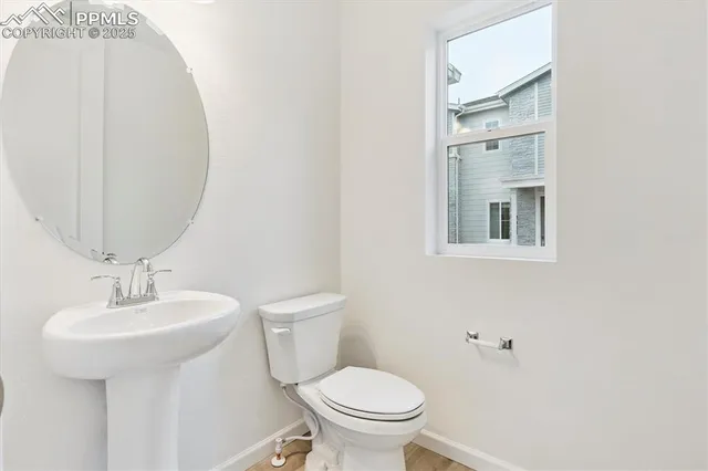 a bathroom with a sink toilet and mirror