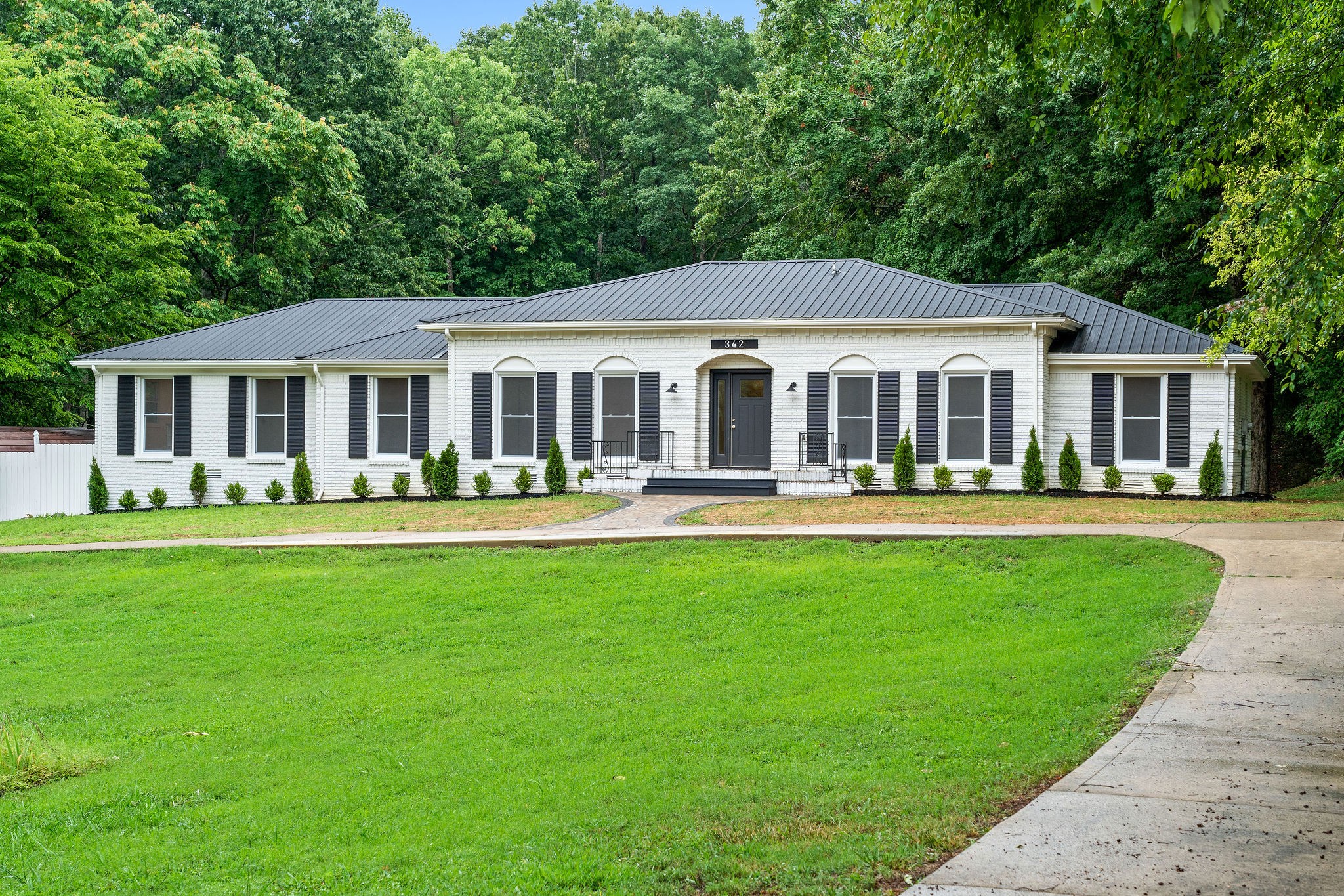 342 Highway 13 Cunningham, TN 37052 - Photo 2 of 44 a front view of a house with a yard table and chairs