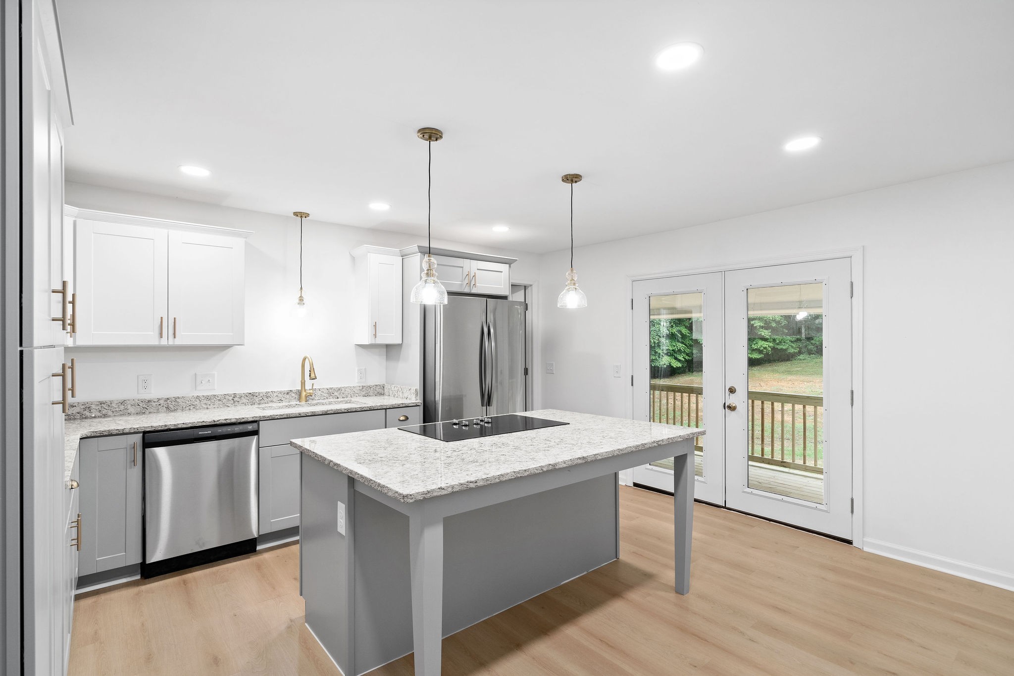342 Highway 13 Cunningham, TN 37052 - Photo 7 of 44 a kitchen with kitchen island granite countertop a stove a sink a center island and wooden floor