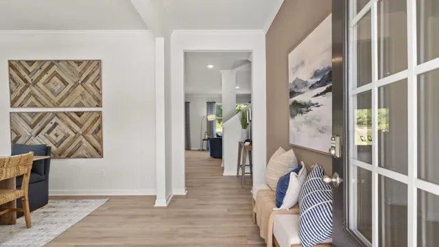 a view of a livingroom with wooden floor and furniture