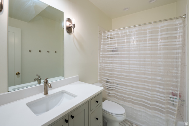 630 East Center Street Alpine, UT 84004 - Photo 74 of 115 Bathroom featuring a light-toned vanity with shaker-style cabinetry, a white countertop with an integrated sink, a brushed nickel faucet, a large rectangular mirror, and a full shower with white subway tile surround and mosaic floor tile
