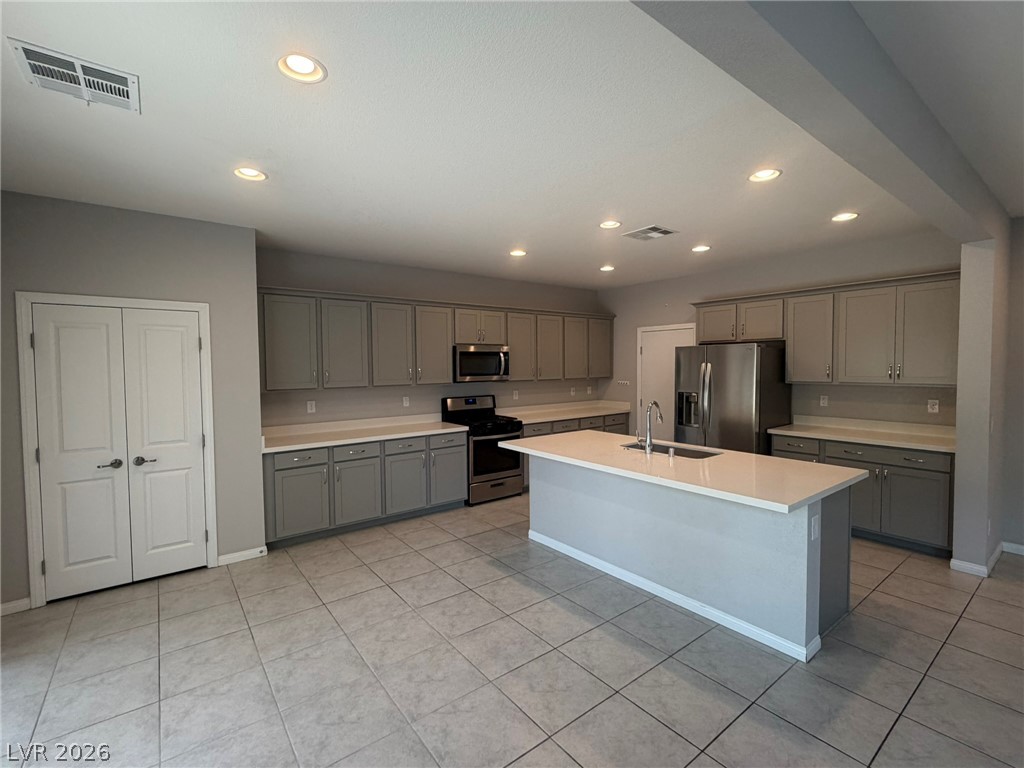 9953 Tucket Point Court Las Vegas, NV 89178 - Photo 7 of 22 Culinary creations come to life in this kitchen, featuring an expansive island and sleek cabinetry.