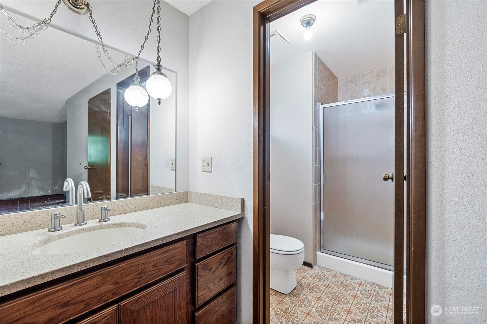 3156 Locker Road Southeast Port Orchard, WA 98366 - Photo 13 of 35 a bathroom with a granite countertop sink toilet a mirror and shower