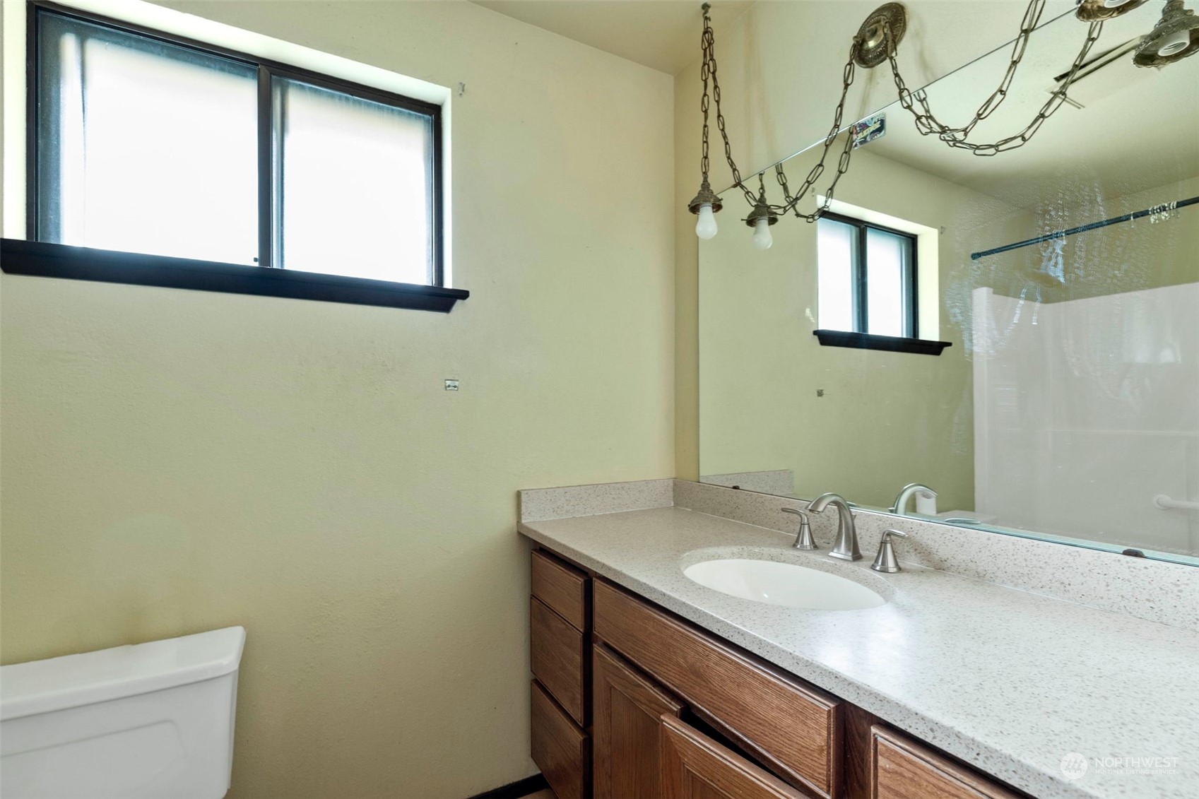 3156 Locker Road Southeast Port Orchard, WA 98366 - Photo 17 of 35 a bathroom with a granite countertop sink a toilet and a mirror