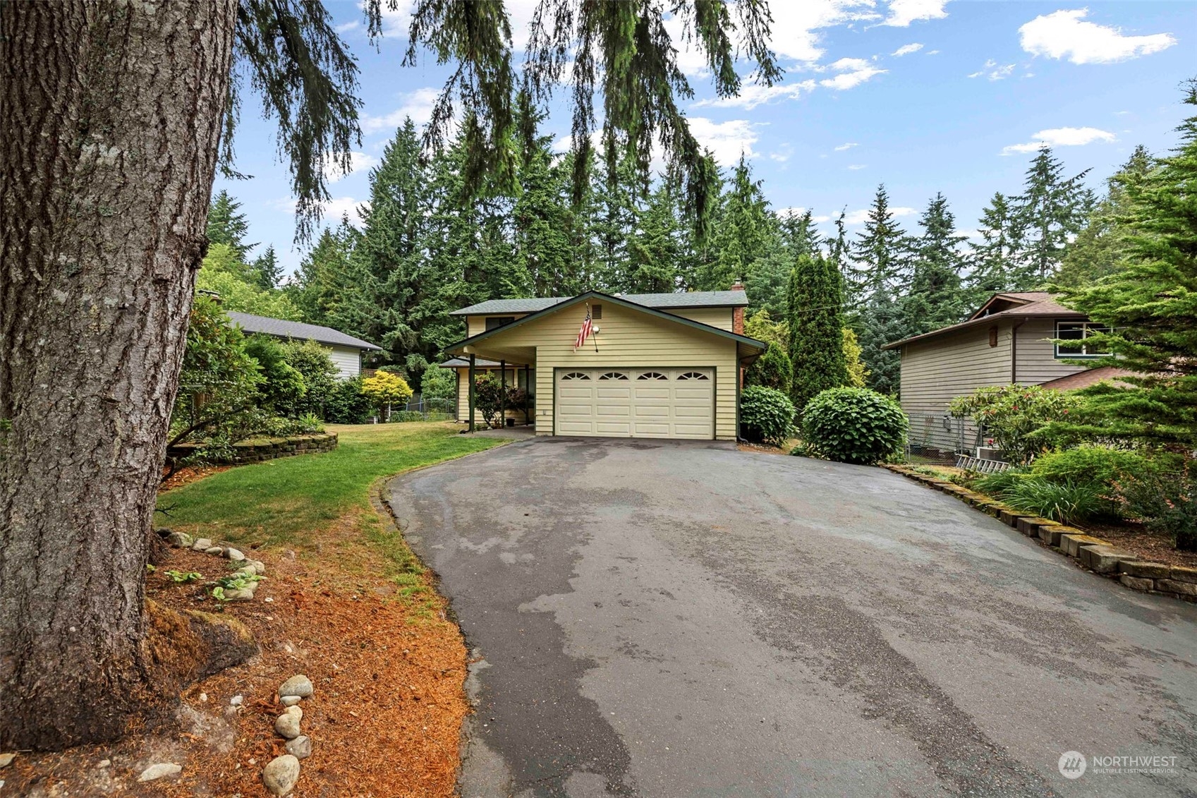 3156 Locker Road Southeast Port Orchard, WA 98366 - Photo 23 of 35 a front view of a house with a yard and garage