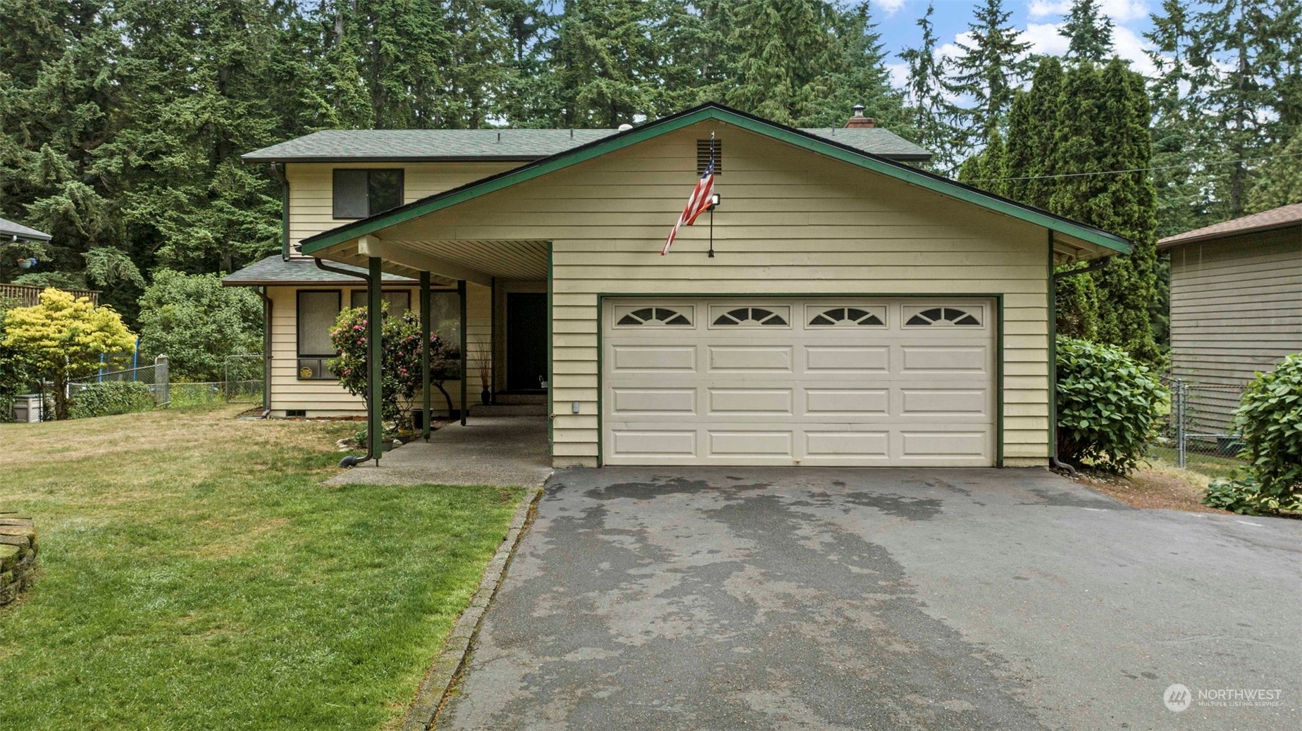 3156 Locker Road Southeast Port Orchard, WA 98366 - Photo 24 of 35 a front view of a house with a yard and garage