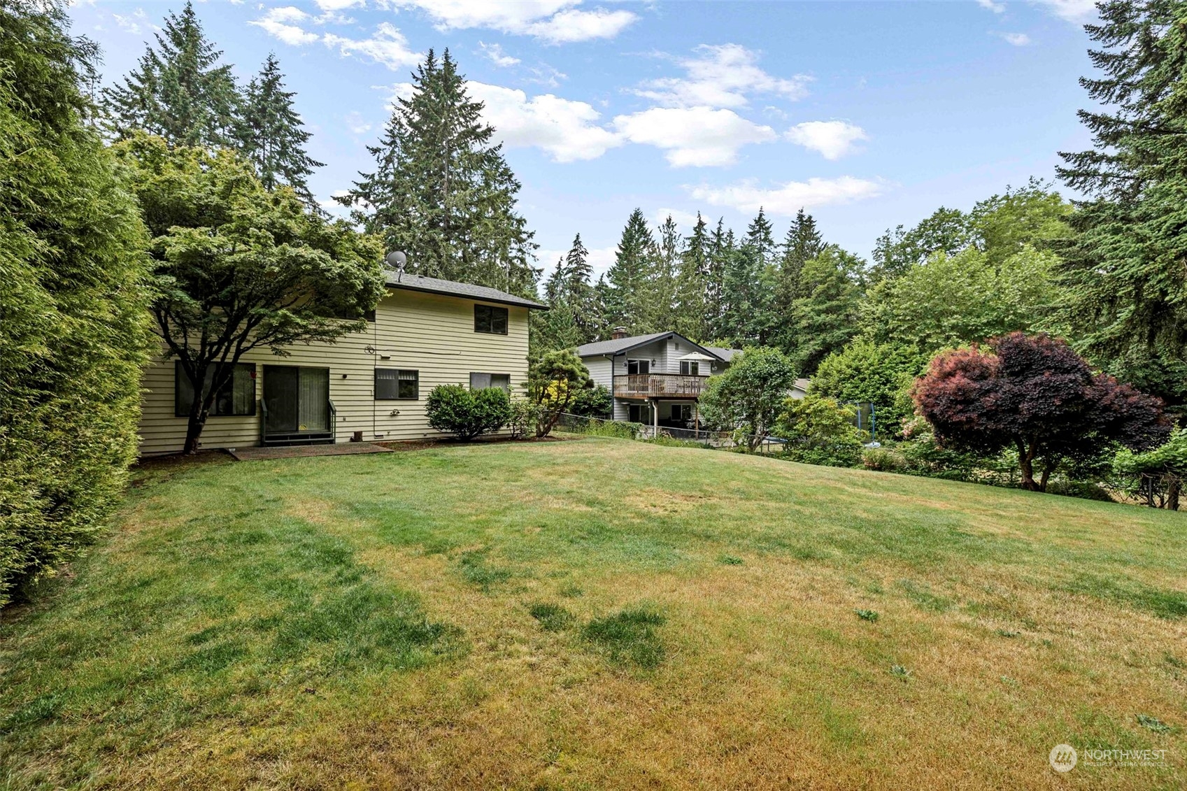 3156 Locker Road Southeast Port Orchard, WA 98366 - Photo 30 of 35 a view of a house with a backyard and trees