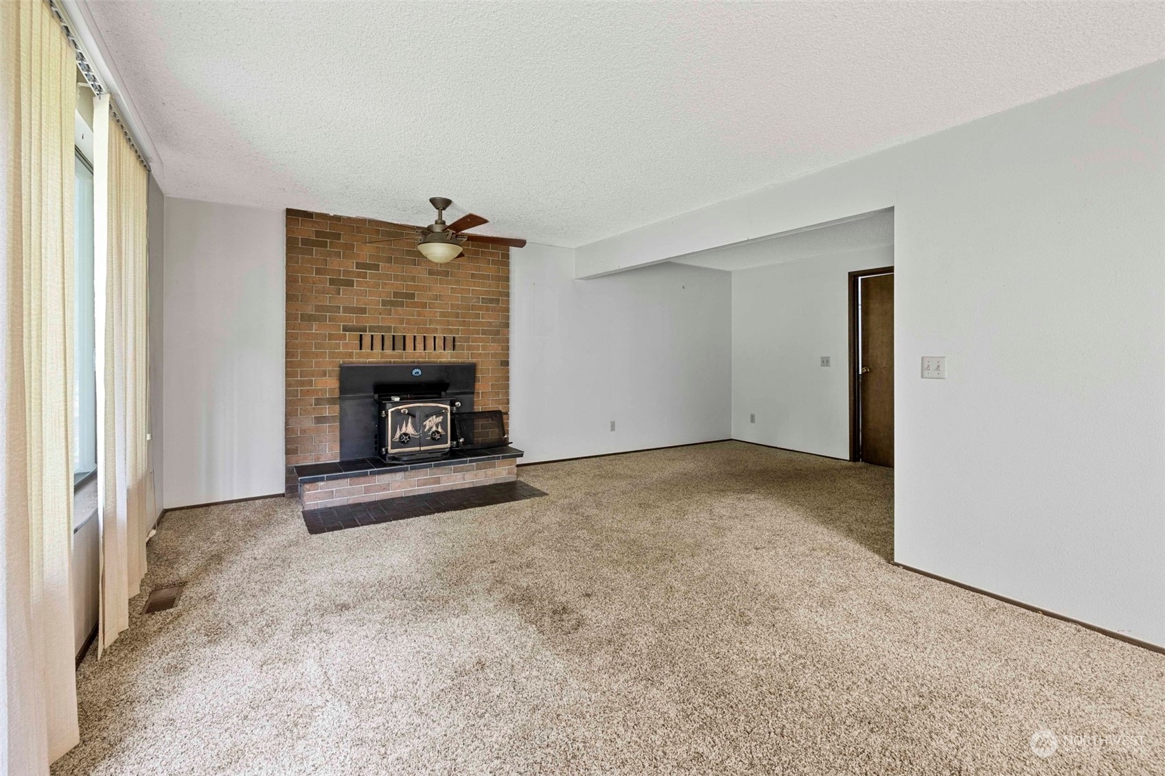 3156 Locker Road Southeast Port Orchard, WA 98366 - Photo 8 of 35 an empty room with furniture and a fireplace