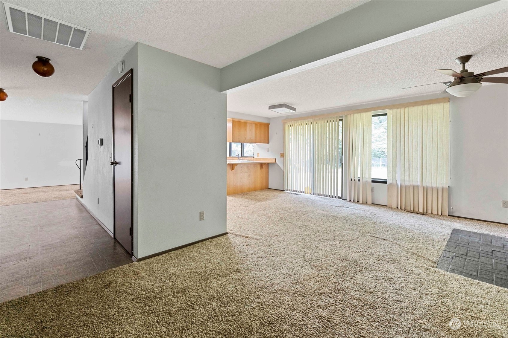 3156 Locker Road Southeast Port Orchard, WA 98366 - Photo 9 of 35 an empty room with windows and chandelier fan