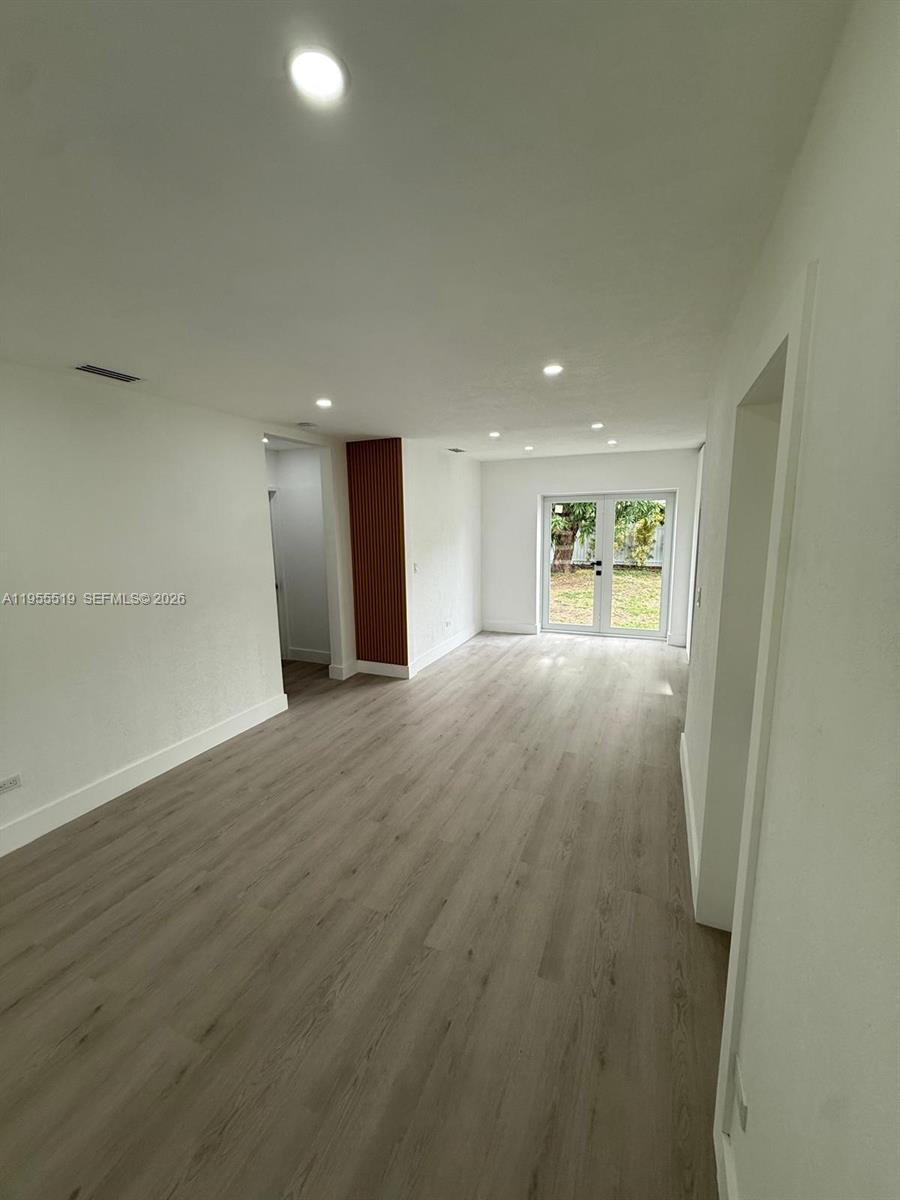 4366 Southwest 5th Terrace Miami, FL 33134 - Photo 11 of 30 an empty room with wooden floor and windows