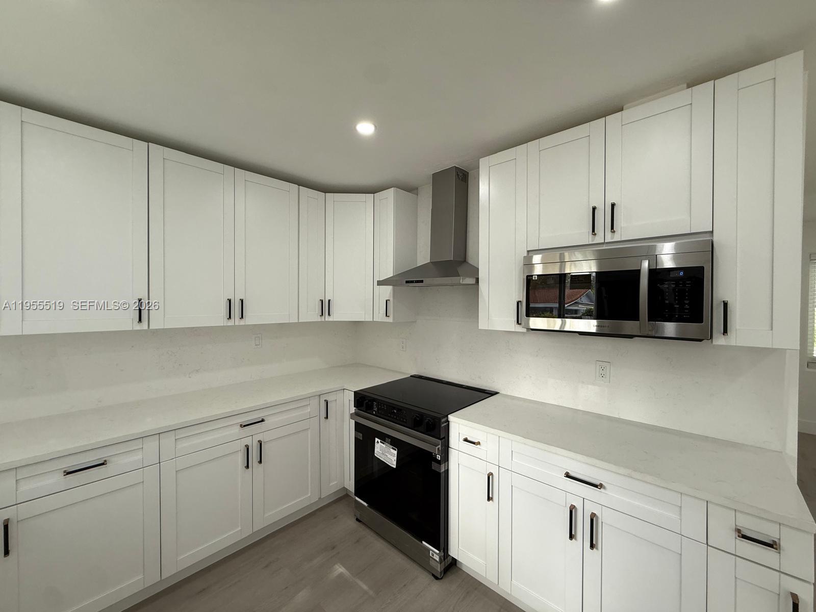 4366 Southwest 5th Terrace Miami, FL 33134 - Photo 15 of 30 a kitchen with stainless steel appliances granite countertop white cabinets a sink and dishwasher
