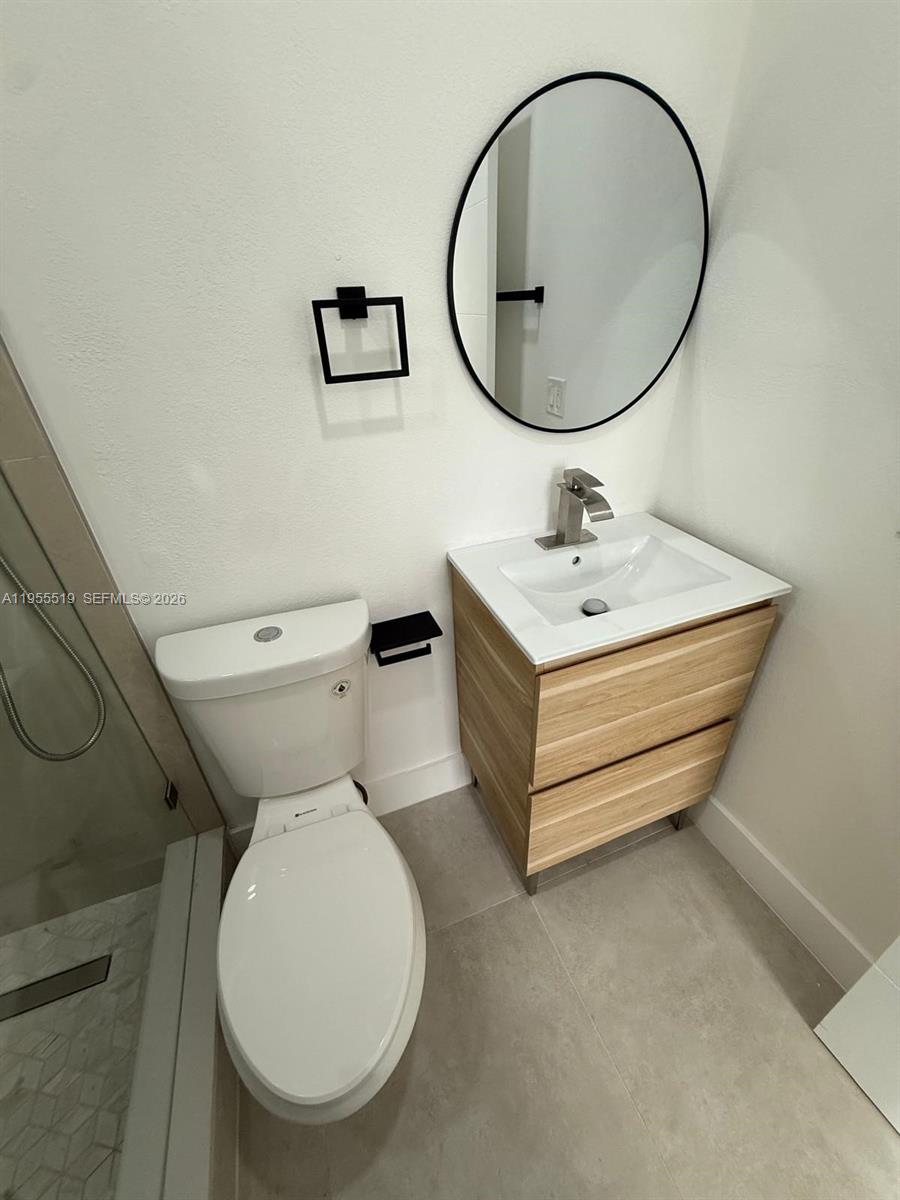 4366 Southwest 5th Terrace Miami, FL 33134 - Photo 20 of 30 a bathroom with a toilet a sink and mirror