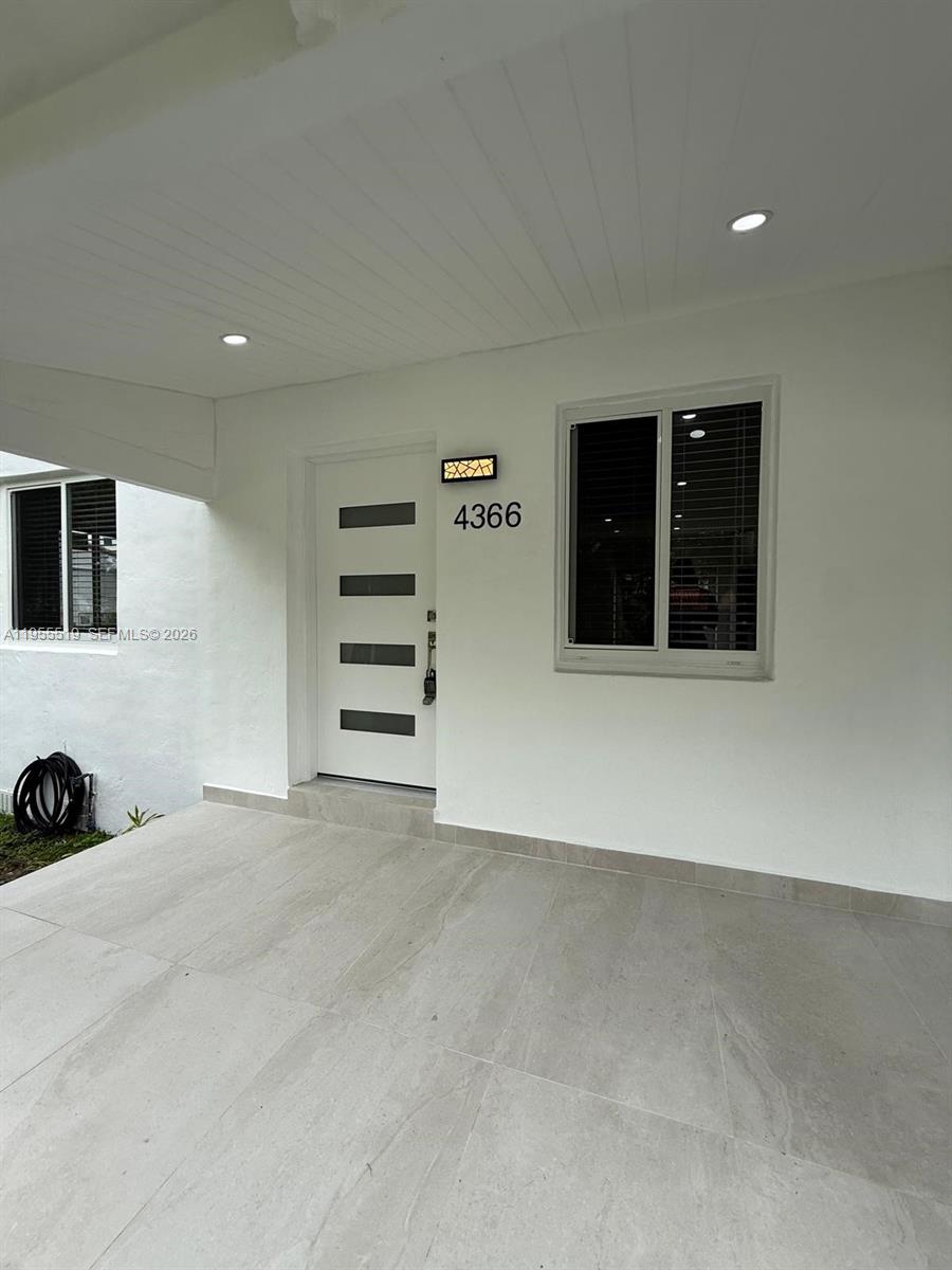 4366 Southwest 5th Terrace Miami, FL 33134 - Photo 7 of 30 an empty room with a fireplace and window