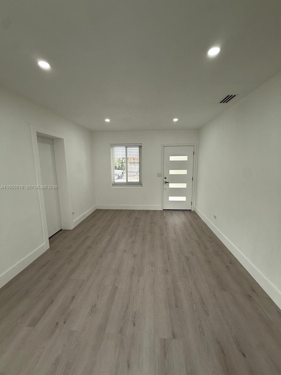 4366 Southwest 5th Terrace Miami, FL 33134 - Photo 9 of 30 an empty room with wooden floor and windows