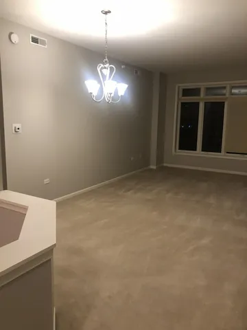 a view of empty room with chandelier