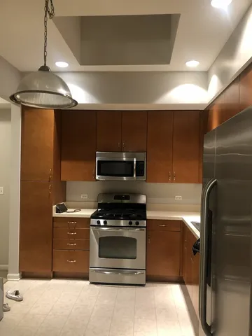 a kitchen with stainless steel appliances granite countertop a stove and a refrigerator