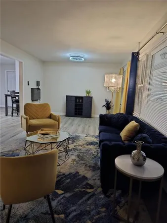 a living room with furniture and a mirror