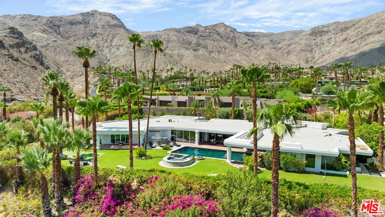 70375 Calico Road Rancho Mirage, CA 92270 - Photo 2 of 46 a view of a swimming pool with a garden and mountain view
