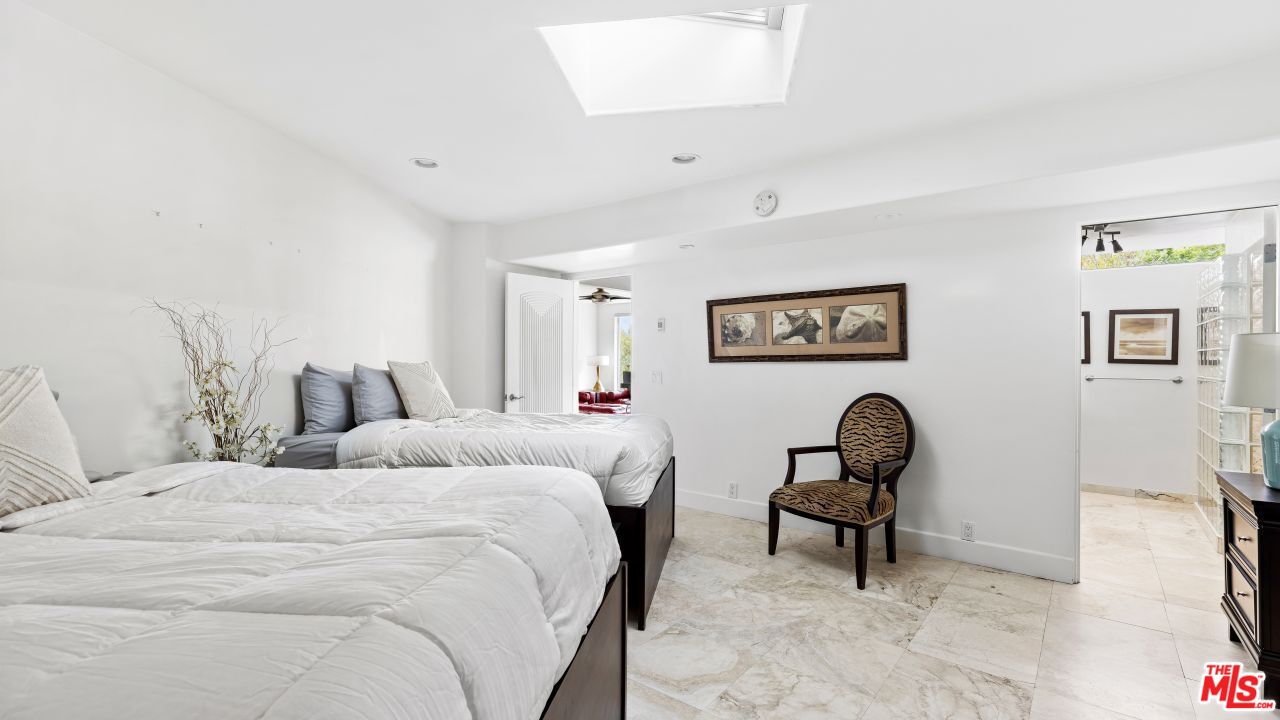 70375 Calico Road Rancho Mirage, CA 92270 - Photo 23 of 46 a bedroom with a bed and a chair