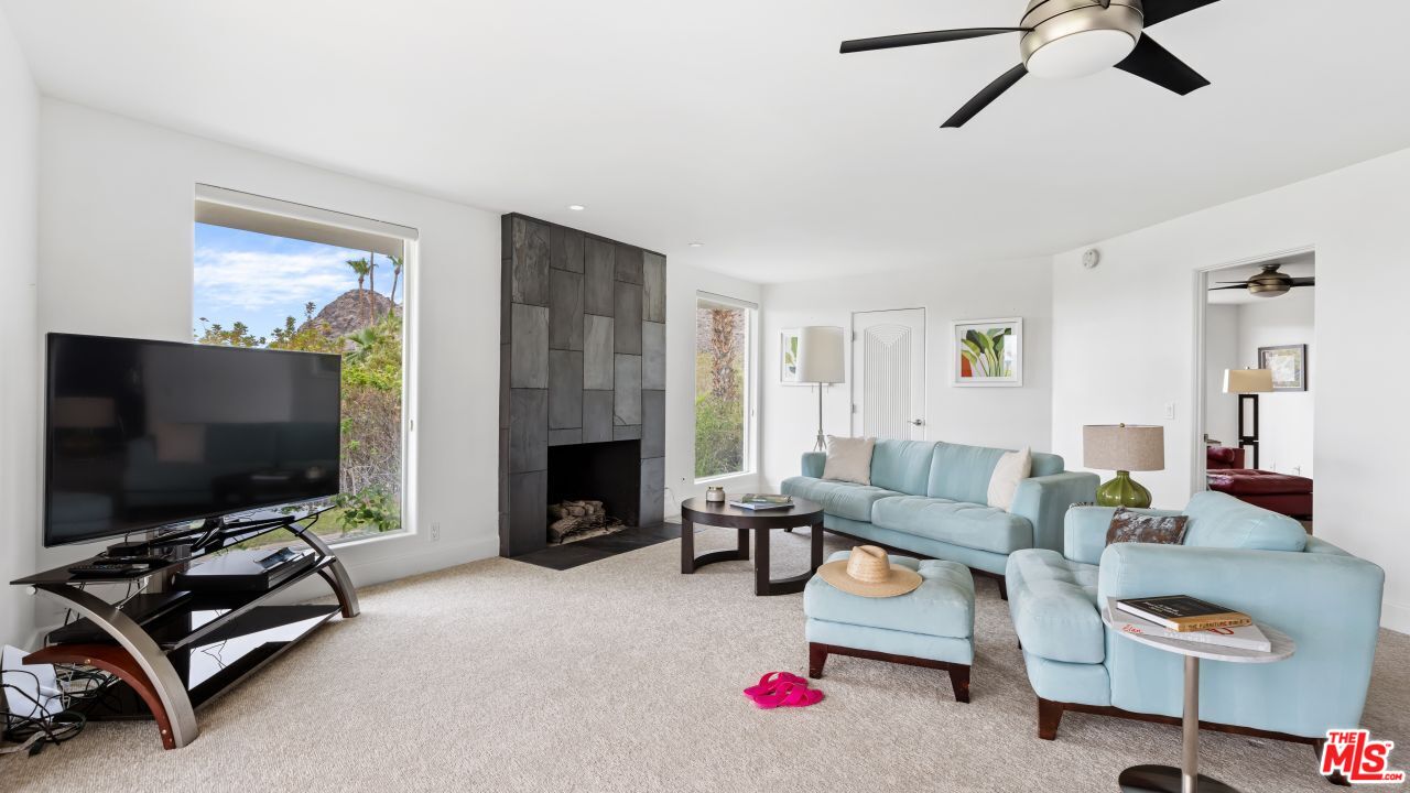 70375 Calico Road Rancho Mirage, CA 92270 - Photo 26 of 46 a living room with furniture flat screen tv and a fireplace