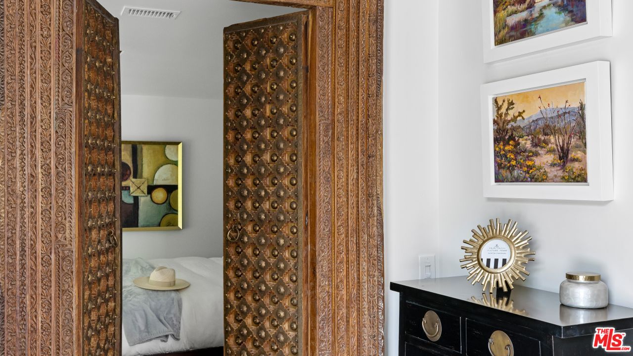 70375 Calico Road Rancho Mirage, CA 92270 - Photo 27 of 46 a view of a hallway with wooden floor and a potted plant