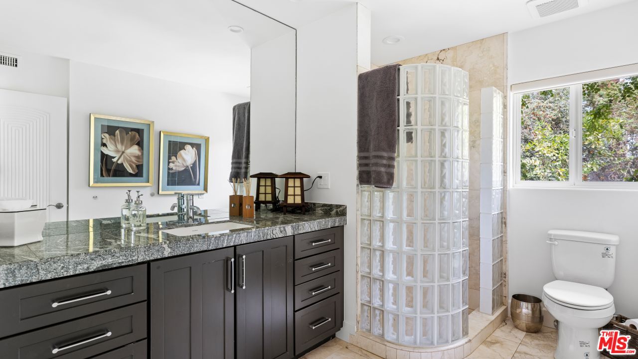 70375 Calico Road Rancho Mirage, CA 92270 - Photo 29 of 46 a bathroom with a granite countertop sink toilet and shower
