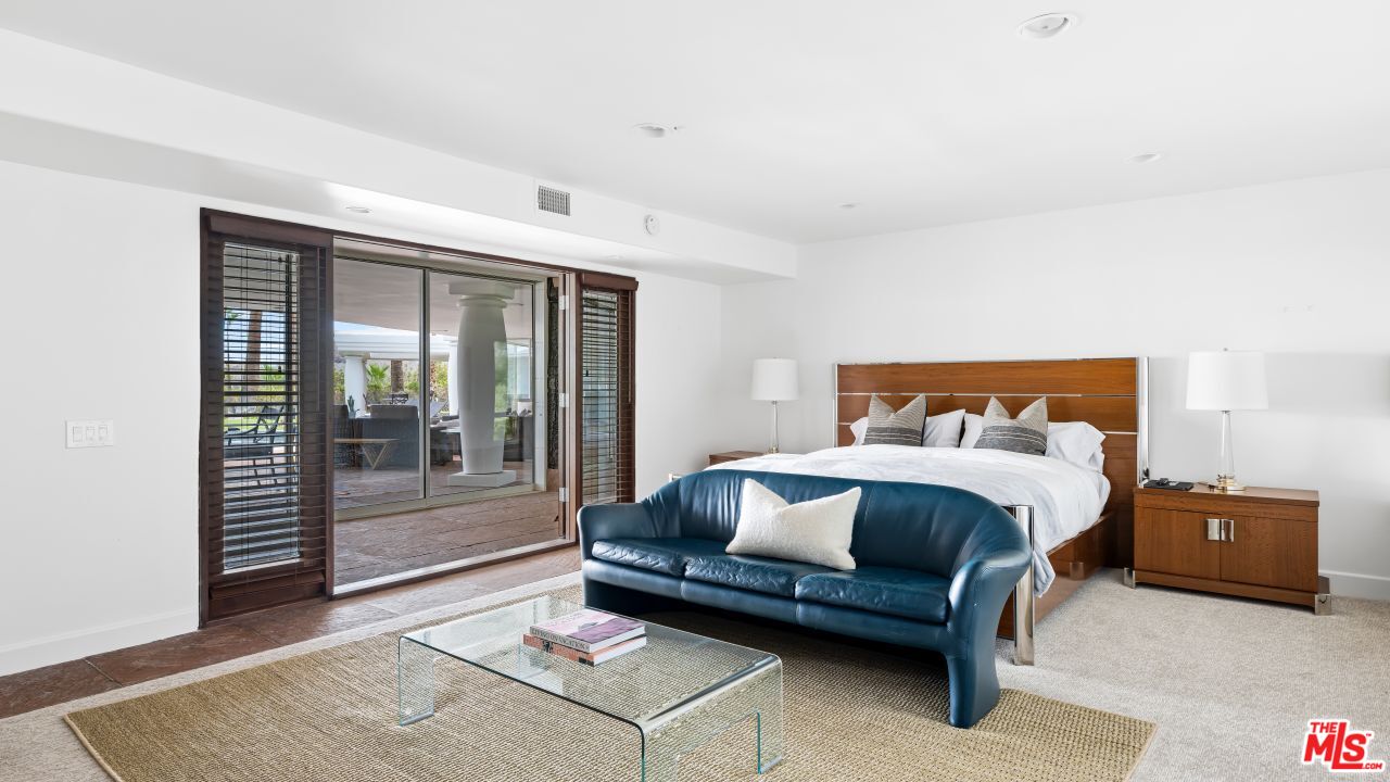 70375 Calico Road Rancho Mirage, CA 92270 - Photo 30 of 46 a bedroom with a bed and glass door