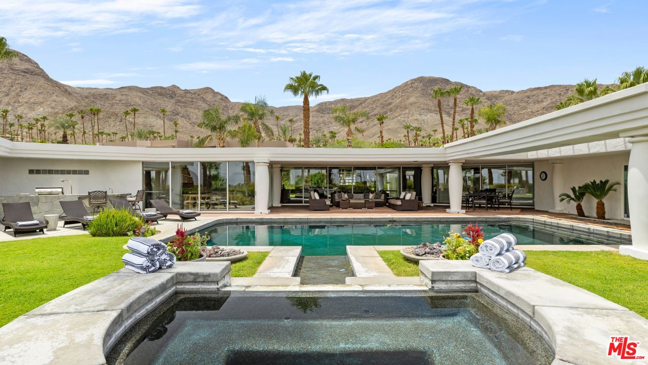 70375 Calico Road Rancho Mirage, CA 92270 - Photo 32 of 46 a view of a house with swimming pool and a chairs