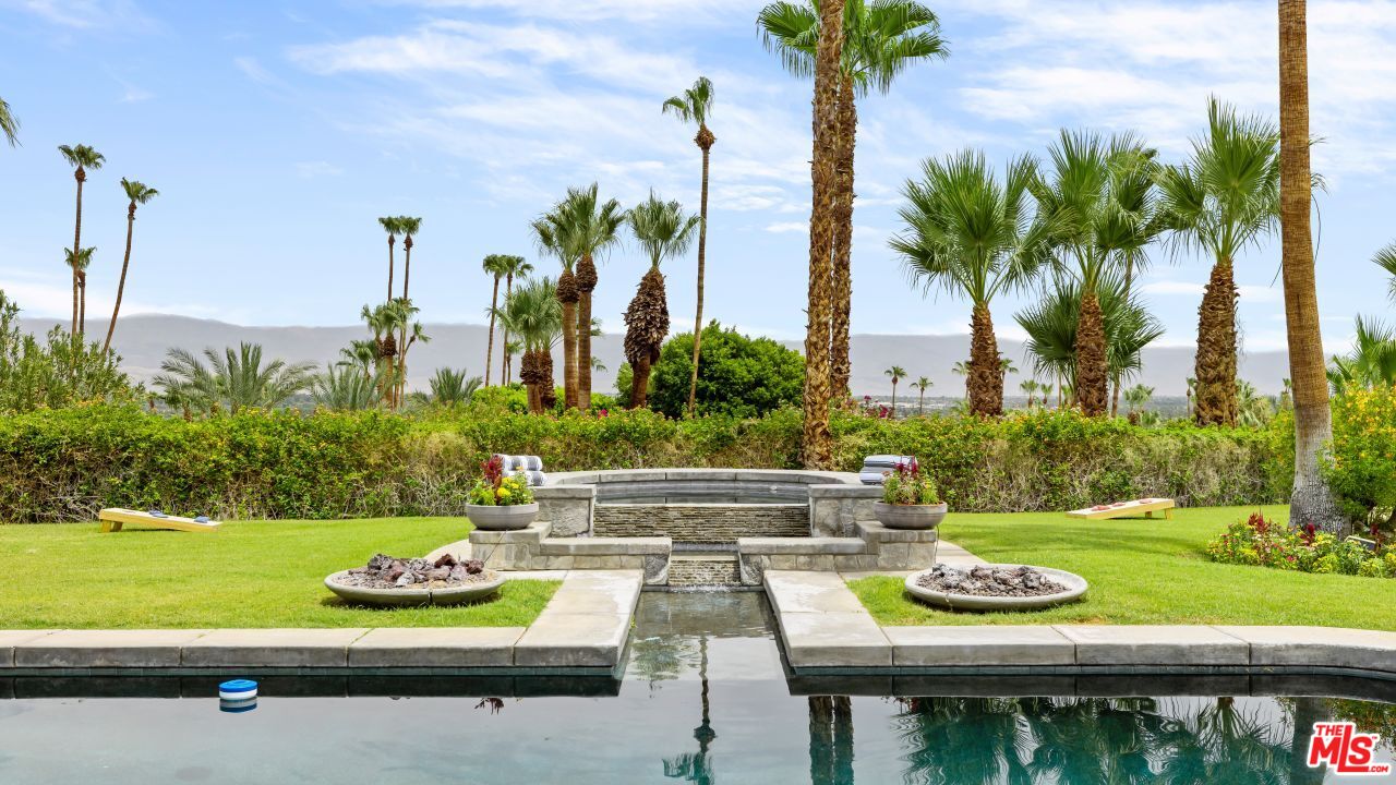 70375 Calico Road Rancho Mirage, CA 92270 - Photo 33 of 46 a view of swimming pool with a patio and a garden