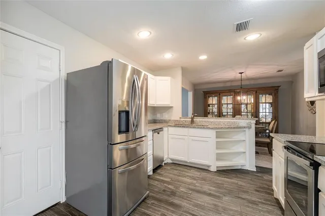 a kitchen with stainless steel appliances a refrigerator sink and stove