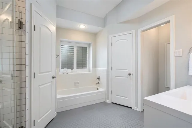 a bathroom with a bathtub and shower