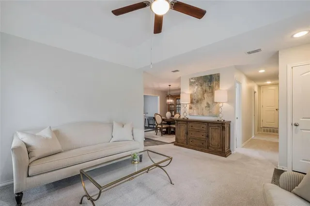 a living room with furniture and a kitchen