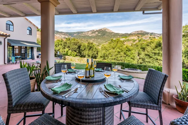 a view of a patio with a table and chairs