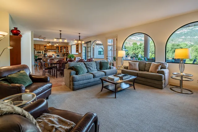 a bedroom with a bed and a dresser next to a window
