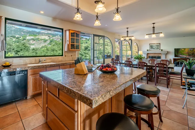 a kitchen with stainless steel appliances granite countertop a sink a stove and a microwave