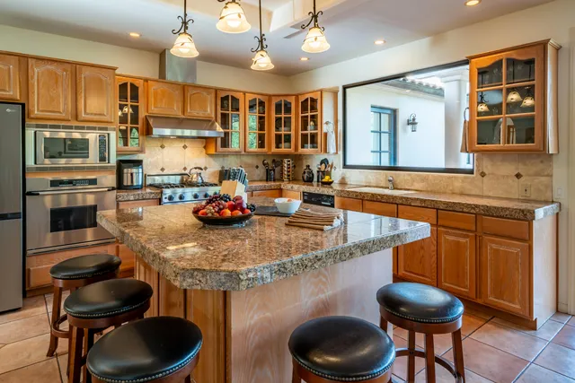 a backyard of a house with table and chairs