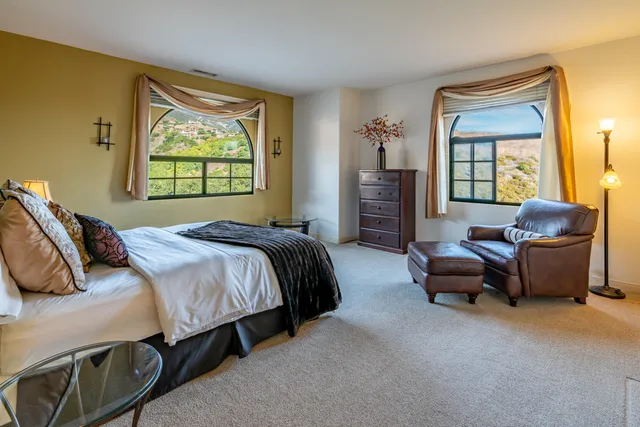 a view of a chair and table in backyard of the house