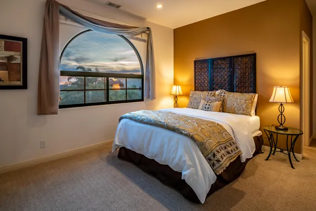 a view of staircase and dining room with wooden floor and a chandelier