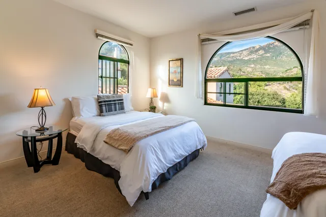 a bedroom with a bed and a lamp