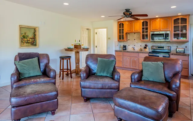 a bathroom with a granite countertop sink a toilet and a mirror