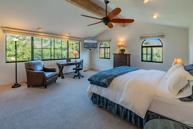 a spacious bedroom with a bed and a window