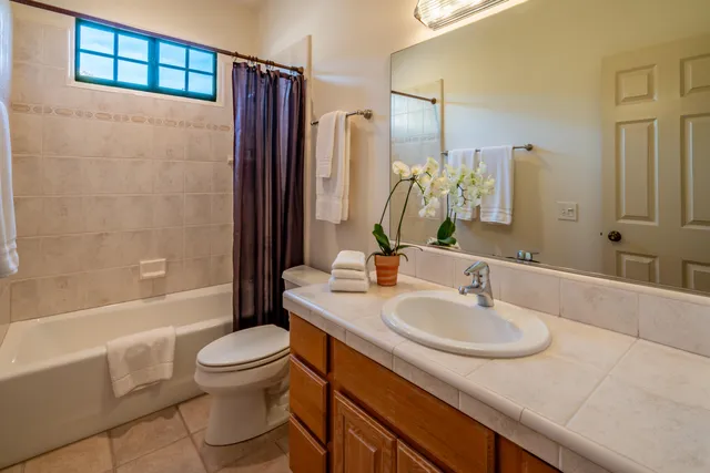 a bedroom with two beds and a window