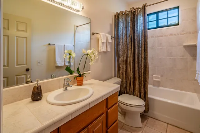 a bathroom with a sink toilet tub and shower