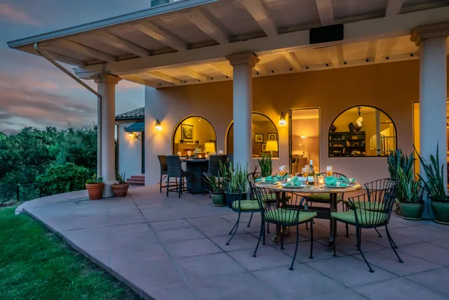 a view of a porch with a table and a garden
