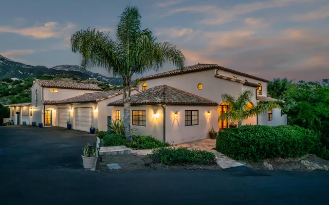 an aerial view of a house with swimming pool garden and patio