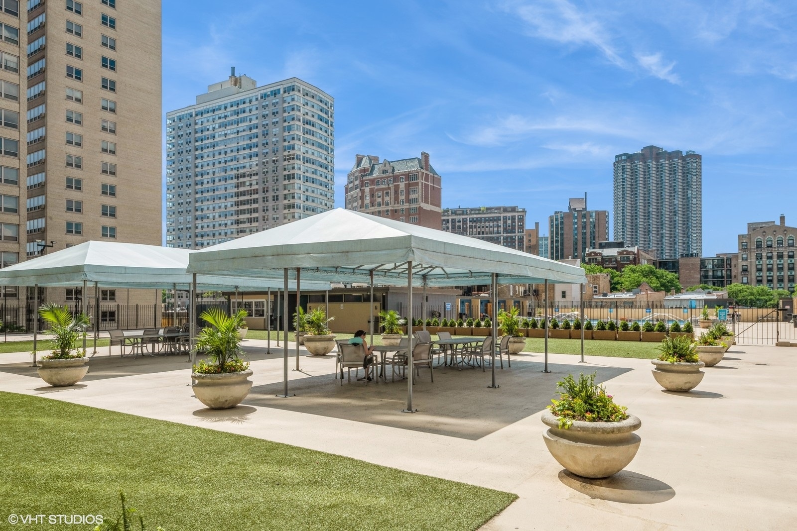 655 West Irving Park Road, Unit 1911 Chicago, IL 60613 - Photo 21 of 27 a patio with a table and chairs