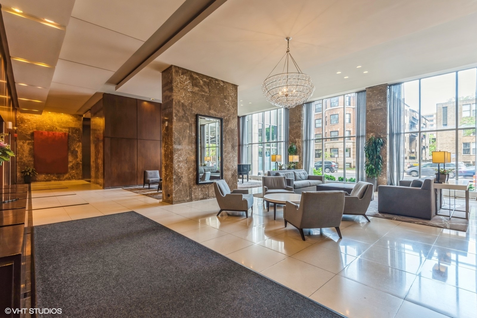 655 West Irving Park Road, Unit 1911 Chicago, IL 60613 - Photo 8 of 27 a living room with furniture a large window and chandelier
